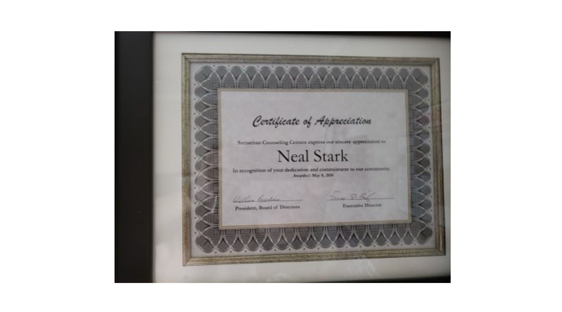 Framed certificate of appreciation with name 'Neal Stark' on a white background